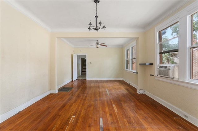 spare room featuring ornamental molding, wood-type flooring, and ceiling fan with notable chandelier