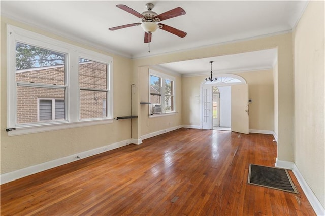 entrance foyer featuring a healthy amount of sunlight, ornamental molding, hardwood / wood-style floors, and ceiling fan