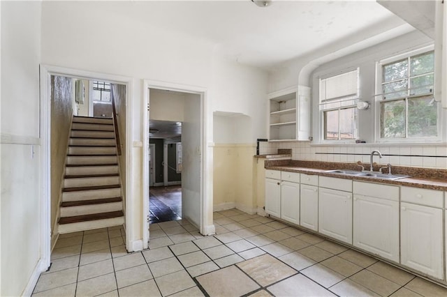 442527 Music St, New Orleans, LA 70122 - kitchen featuring a sink, open shelves, plenty of natural light, and white cabinetry