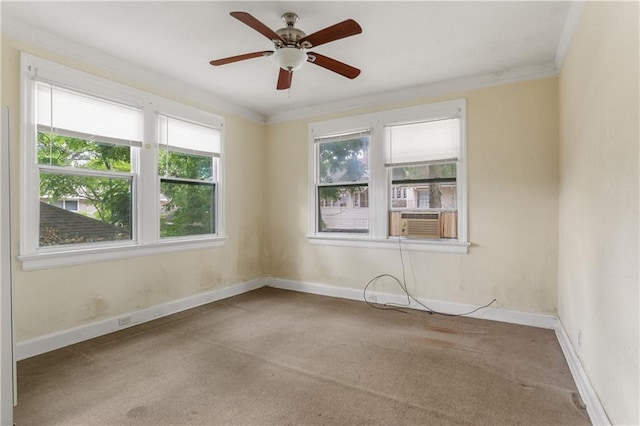 carpeted spare room featuring ornamental molding, cooling unit, ceiling fan, and plenty of natural light