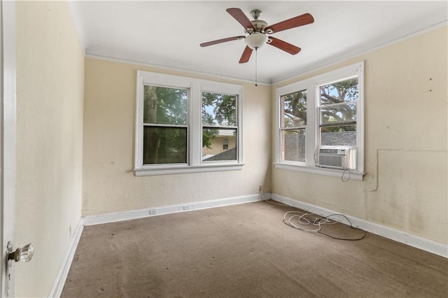 carpeted spare room with ornamental molding, cooling unit, and ceiling fan