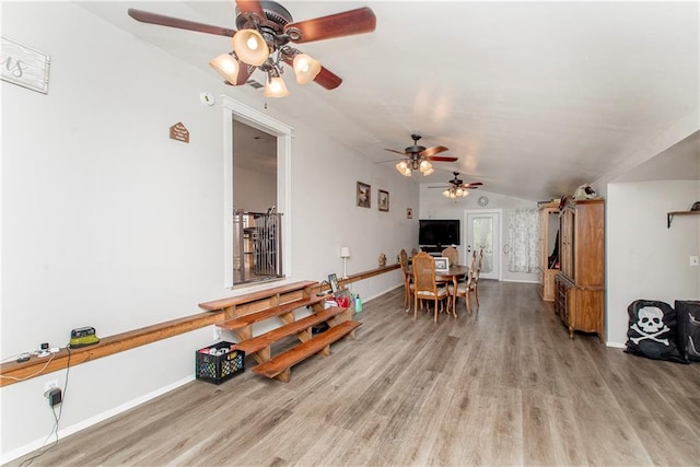 sitting room with ceiling fan, hardwood / wood-style flooring, and vaulted ceiling