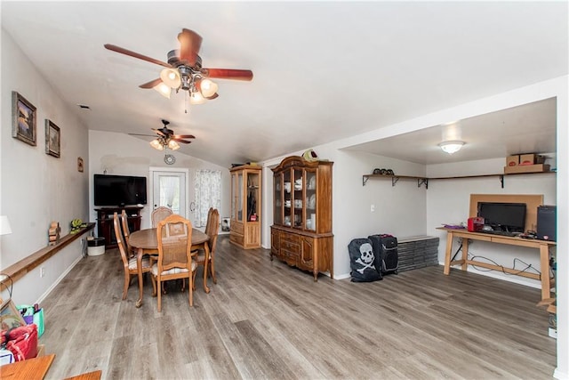 dining area featuring light wood-type flooring, vaulted ceiling, and ceiling fan