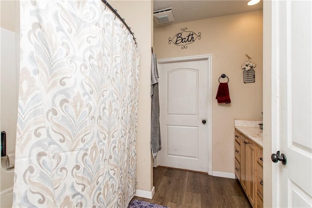 bathroom with vanity, a shower with shower curtain, and hardwood / wood-style flooring