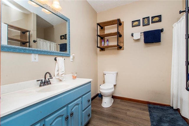 bathroom featuring vanity, toilet, and hardwood / wood-style floors