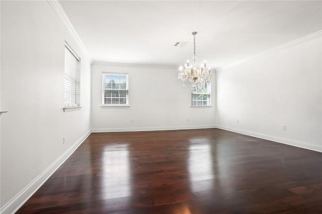 unfurnished room with ornamental molding, an inviting chandelier, and dark wood-type flooring