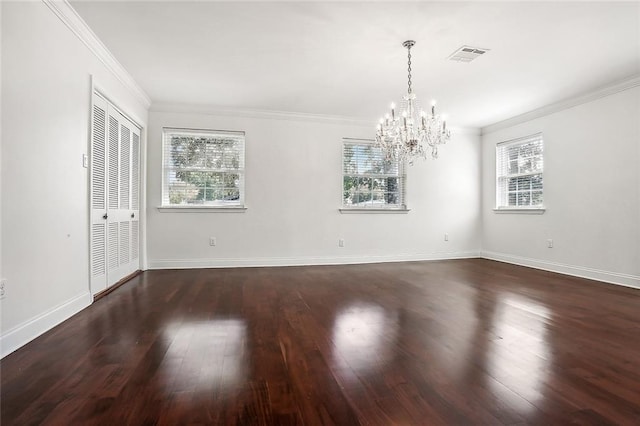 unfurnished room featuring ornamental molding, a chandelier, and dark wood-type flooring