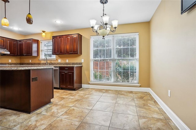 kitchen featuring hanging light fixtures, light tile patterned floors, a chandelier, and a wealth of natural light