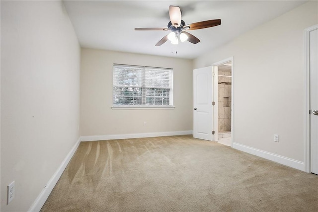 unfurnished bedroom with light carpet, ceiling fan, and ensuite bathroom