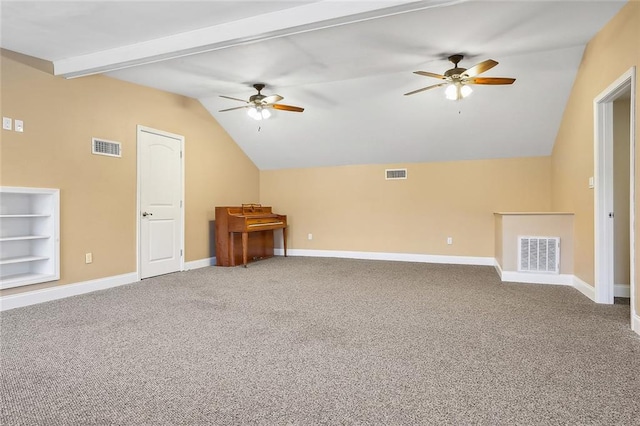 unfurnished living room with vaulted ceiling with beams, ceiling fan, carpet flooring, and built in features