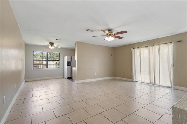 spare room featuring ceiling fan and light tile patterned flooring