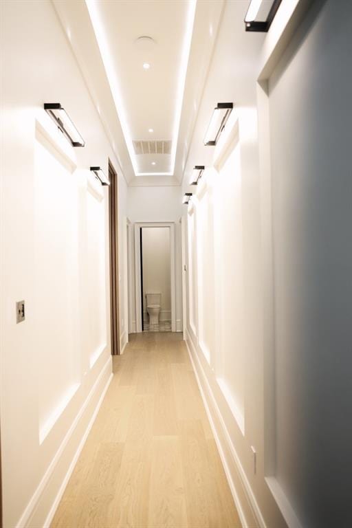 hallway with light hardwood / wood-style flooring