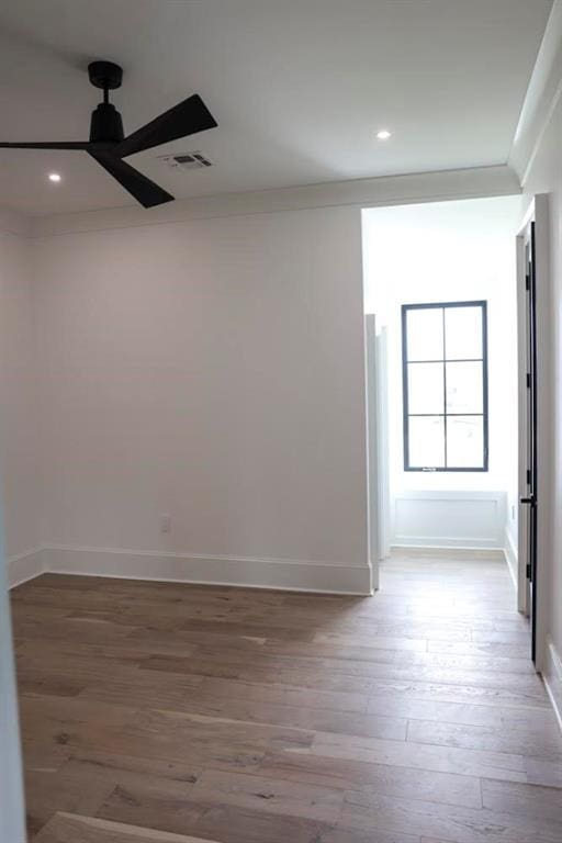 empty room featuring ceiling fan and hardwood / wood-style flooring