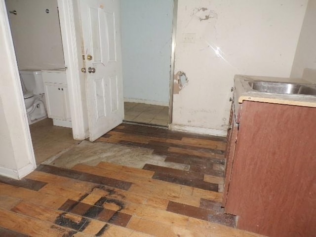 bathroom with toilet, hardwood / wood-style flooring, and sink