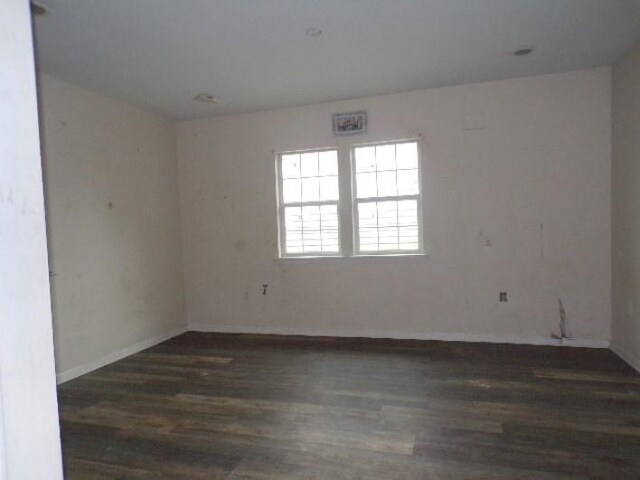 empty room with dark wood-type flooring