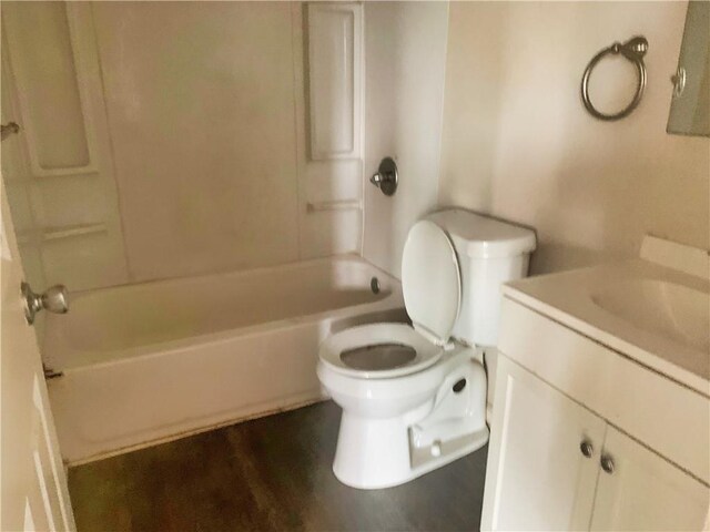 full bathroom with vanity, toilet, shower / bathtub combination, and hardwood / wood-style flooring