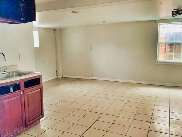 interior space with light tile patterned floors and sink