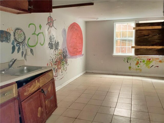 interior space featuring light tile patterned floors and sink