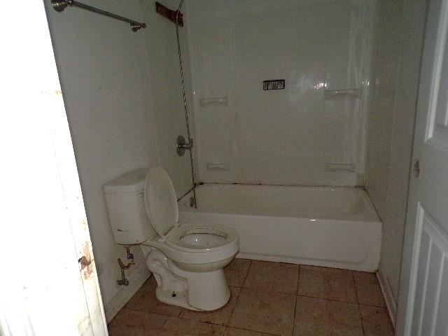 bathroom with toilet, tile patterned floors, and shower / bath combination