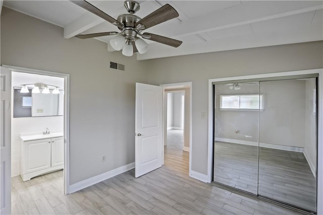 unfurnished bedroom featuring ceiling fan, a closet, and light hardwood / wood-style flooring