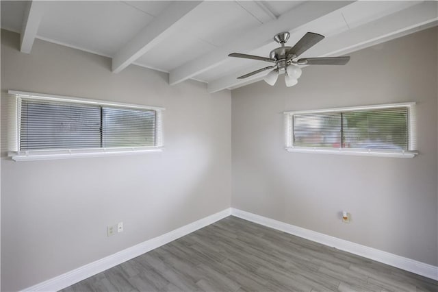 spare room with vaulted ceiling with beams, ceiling fan, and hardwood / wood-style flooring