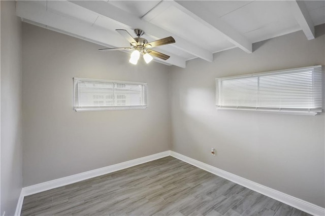 unfurnished room with ceiling fan, lofted ceiling with beams, and wood-type flooring