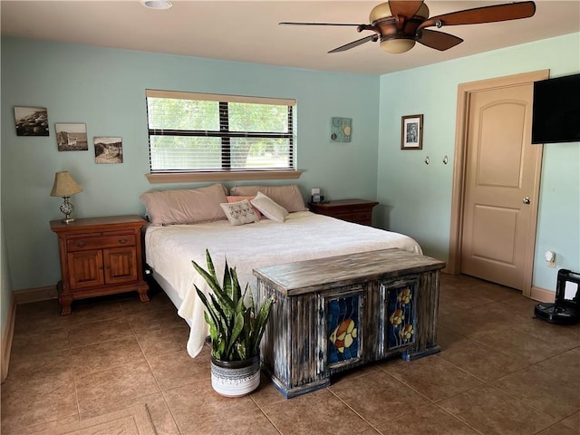 bedroom with ceiling fan and tile patterned flooring