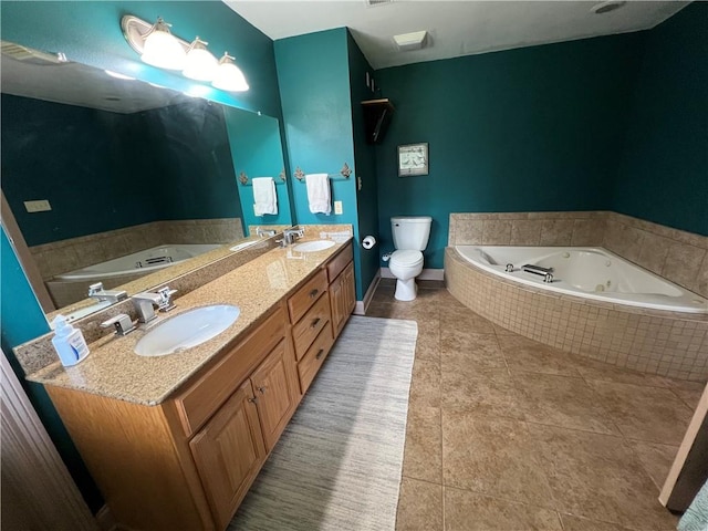 bathroom featuring vanity, toilet, tile patterned flooring, and tiled bath