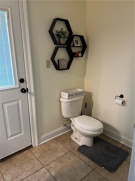 bathroom with toilet and tile patterned floors