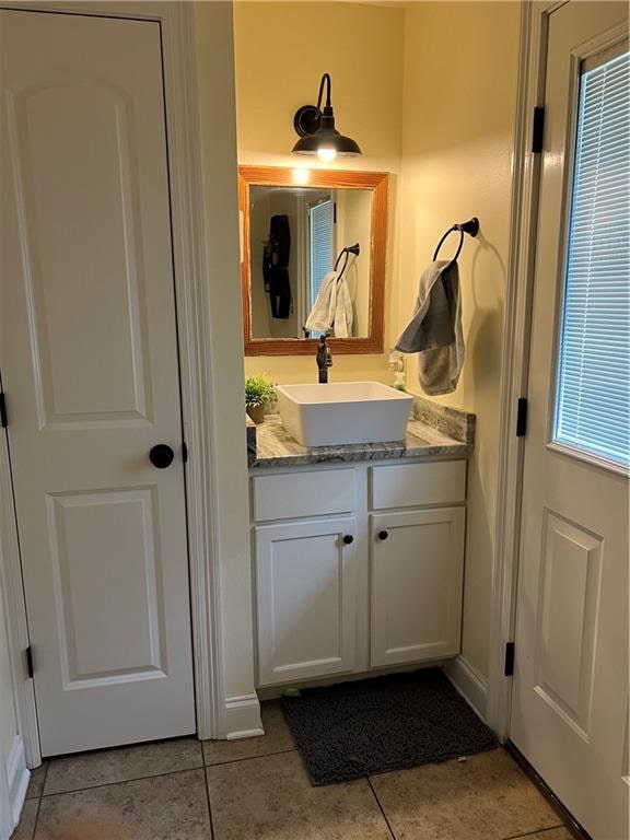 bathroom with tile patterned flooring and vanity