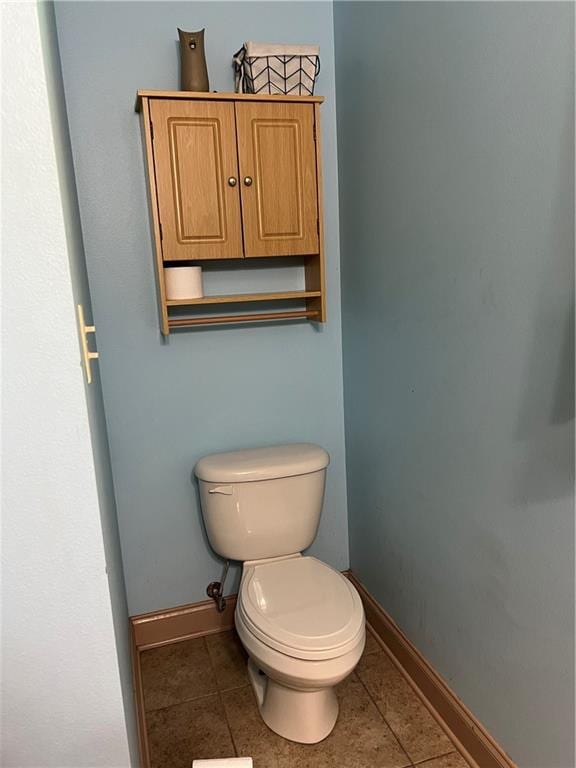 bathroom with toilet and tile patterned floors