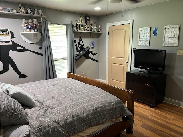 bedroom with ceiling fan and hardwood / wood-style flooring