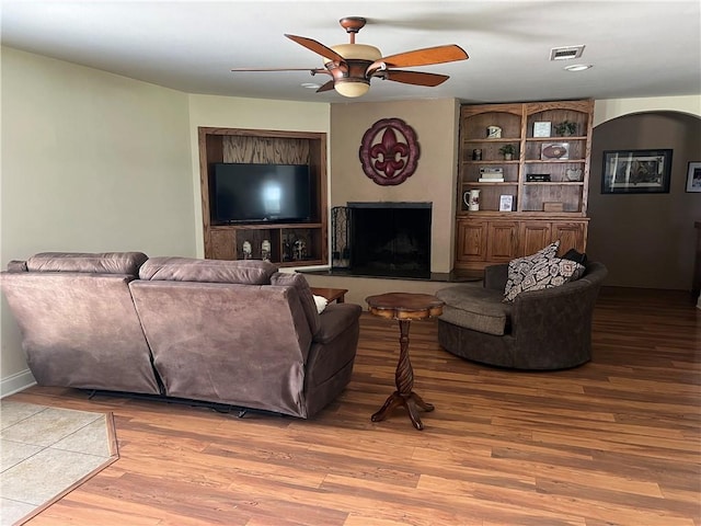 living room featuring ceiling fan and wood-type flooring