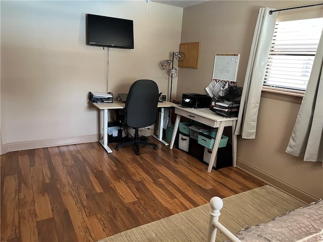 home office with dark hardwood / wood-style flooring