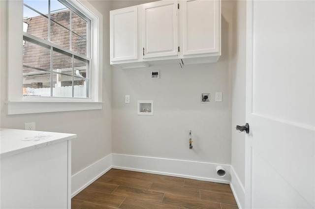 2634 St Ann St, New Orleans, LA 70119 - laundry area featuring hookup for an electric dryer, cabinet space, washer hookup, and healthy amount of natural light