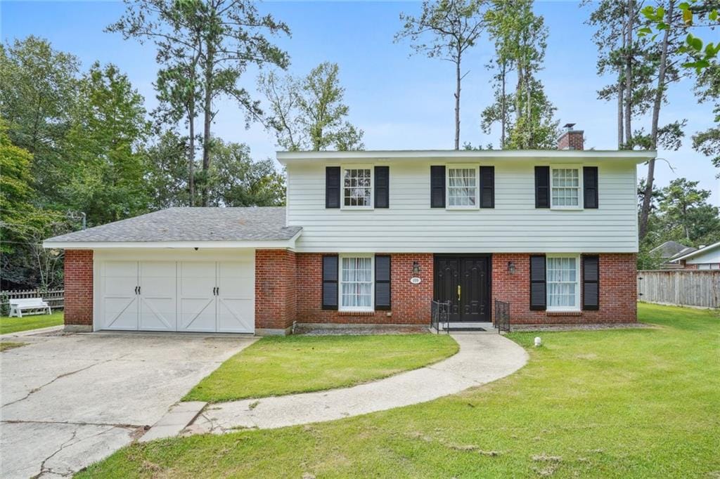 view of front facade with a front yard and a garage