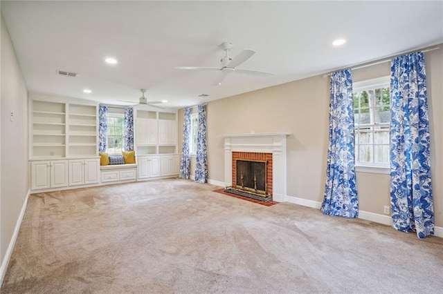 unfurnished living room with light carpet, plenty of natural light, and ceiling fan