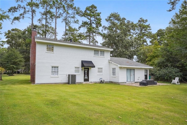 rear view of property with a patio and a lawn