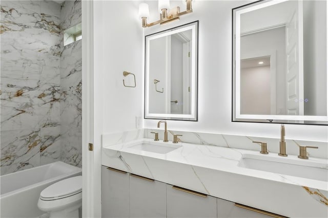 full bathroom with tiled shower / bath, vanity, and toilet