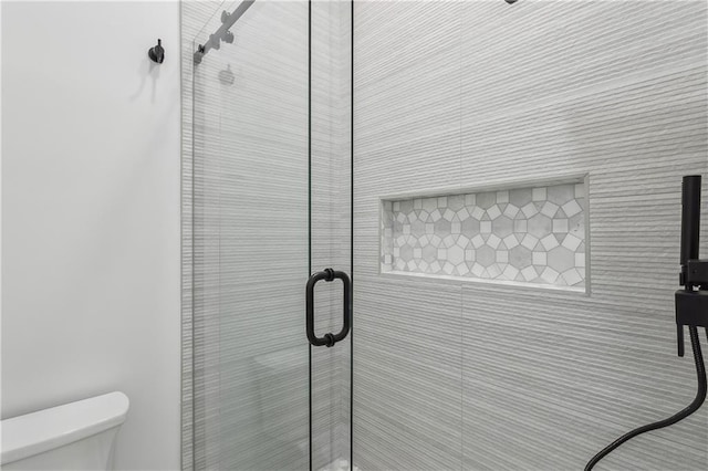 bathroom with toilet and walk in shower