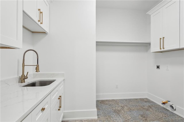 washroom featuring cabinets, sink, hookup for an electric dryer, and hookup for a gas dryer