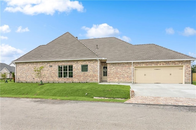 view of front of home with a front lawn and a garage