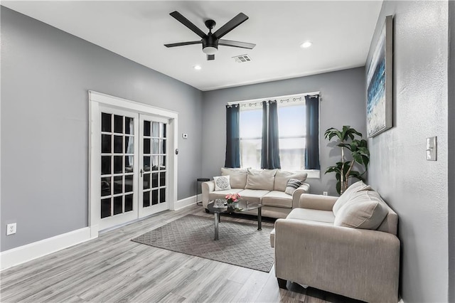 living room featuring ceiling fan and wood-type flooring