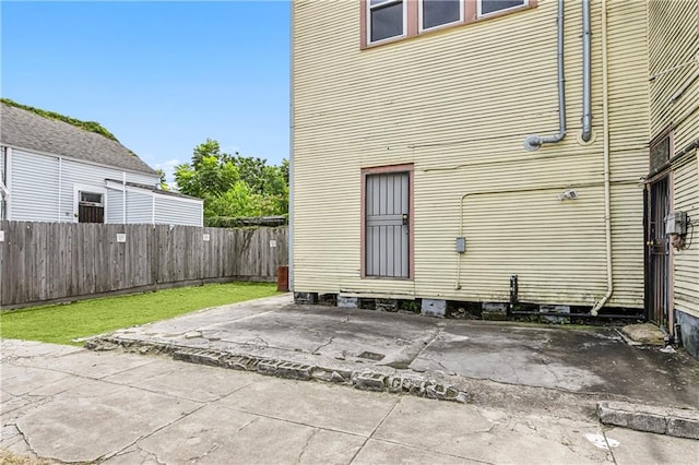 rear view of house featuring a patio area and a yard