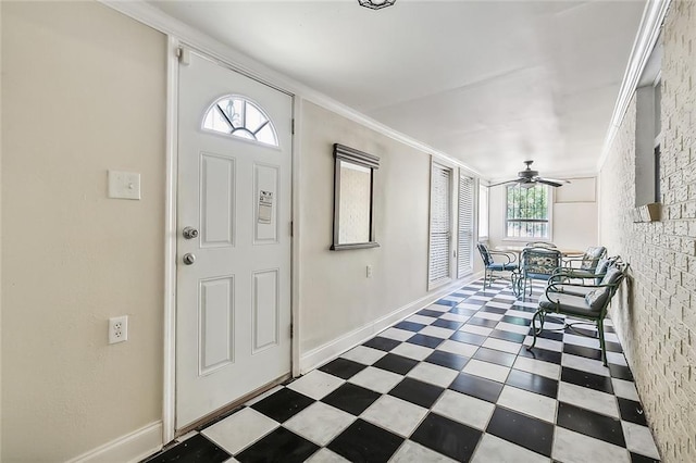 entrance foyer with ornamental molding and ceiling fan