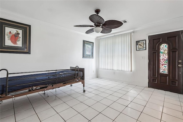 entrance foyer with ceiling fan, light tile patterned floors, and crown molding