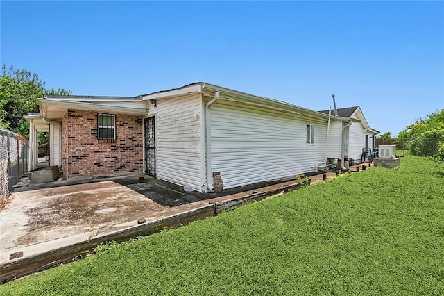 back of house with a yard and a patio