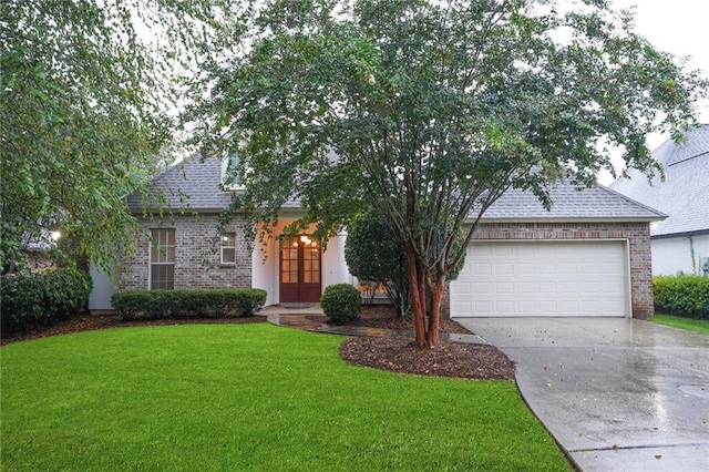 view of front of property with a garage and a front lawn