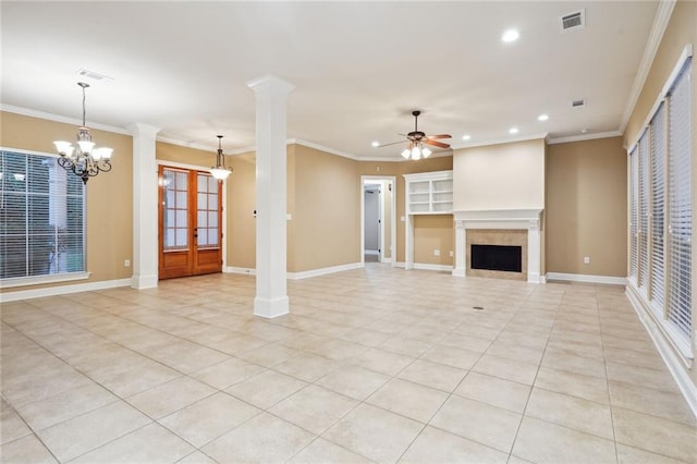 unfurnished living room with light tile patterned floors, ceiling fan with notable chandelier, a fireplace, and ornamental molding