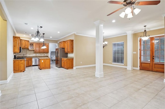 kitchen featuring hanging light fixtures, a kitchen island, stainless steel appliances, ceiling fan with notable chandelier, and ornate columns